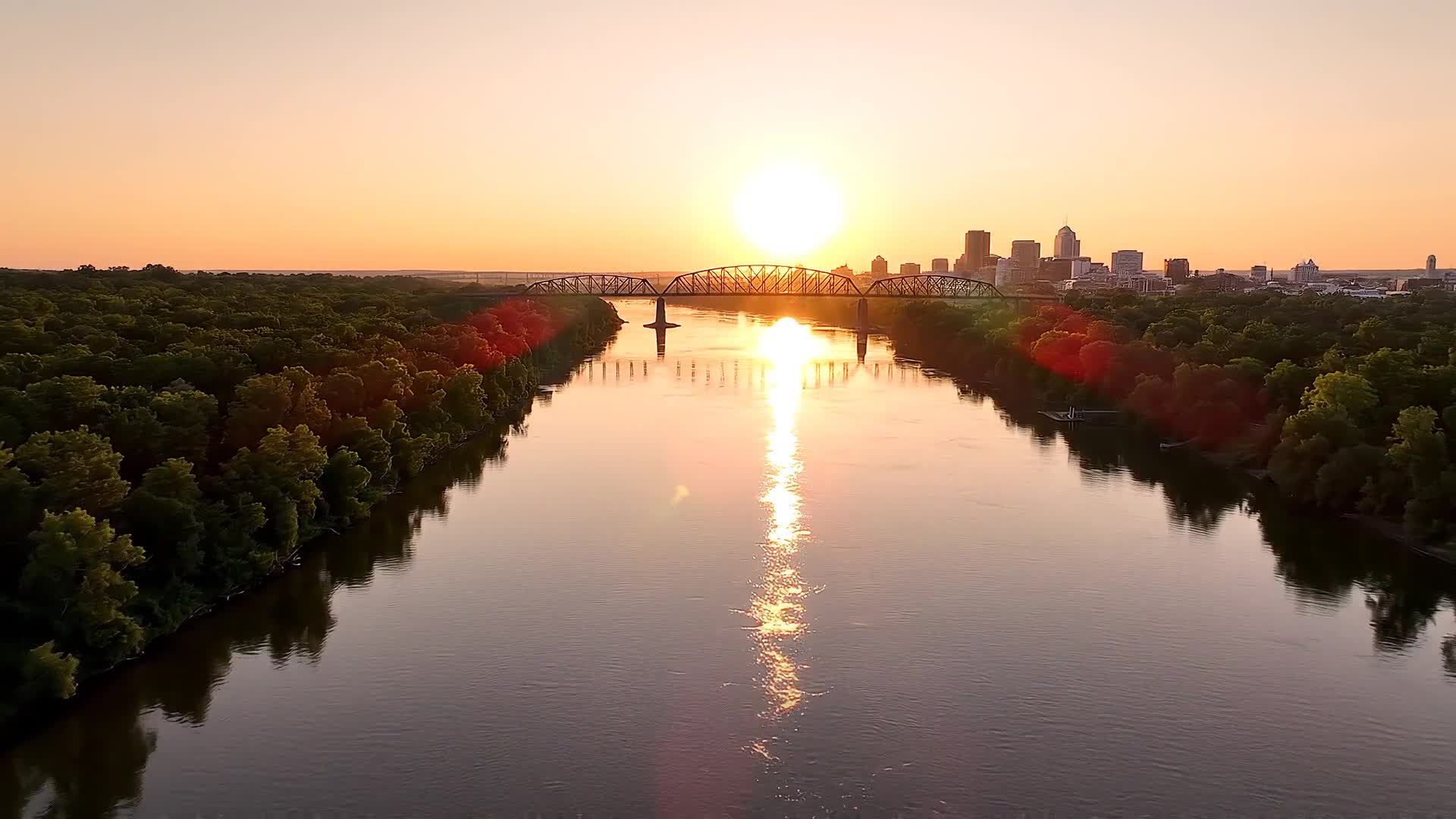 The Little Rock skyline and Arkansas River at sunset, illustrative